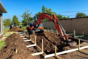 homeguide-excavator-digging-a-swimming-pool-in-a-residential-backyard